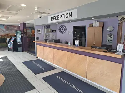 a reception area of a restaurant with a counter at Britannia Edinburgh Hotel in Edinburgh