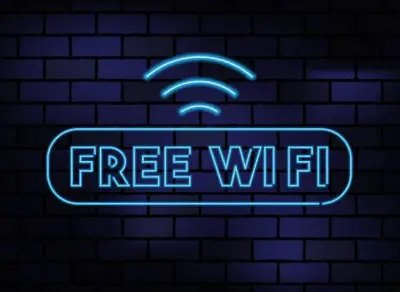 a neon sign with a free wifi sign on a brick wall at Britannia Edinburgh Hotel in Edinburgh