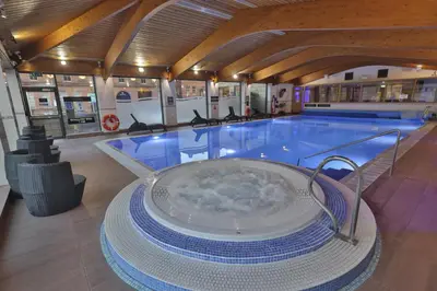 a large swimming pool with a hot tub in a building at Glasgow Argyle Hotel, BW Signature Collection in Glasgow