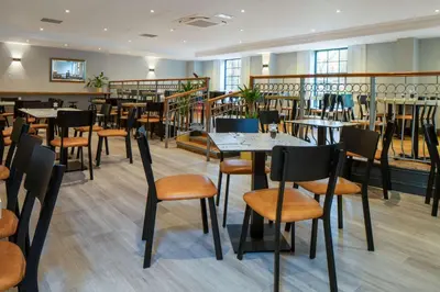 a restaurant with tables and chairs in a room at Glasgow Argyle Hotel, BW Signature Collection in Glasgow