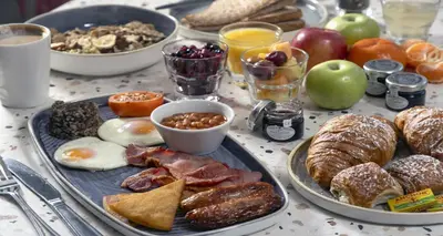 a table with plates of breakfast foods on it at Glasgow Argyle Hotel, BW Signature Collection in Glasgow
