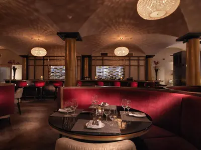 a restaurant with a table with wine glasses on it at Malmaison Glasgow in Glasgow