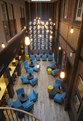 an overhead view of a restaurant with blue chairs and tables at Malmaison Glasgow in Glasgow