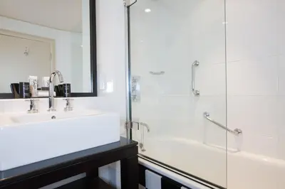 a bathroom with a tub and a sink and a shower at Malmaison Glasgow in Glasgow