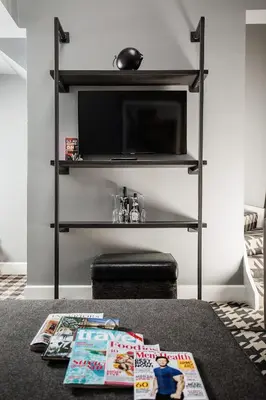 a living room with a tv and a table with magazines at Malmaison Glasgow in Glasgow
