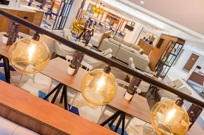a view of a restaurant with tables and chairs at Courtyard by Marriott Glasgow Airport in Paisley