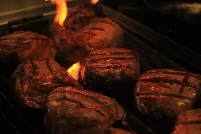 a group of meat being cooked on a grill at Annandale Arms Hotel in Moffat