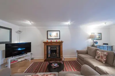 a living room with a couch and a fireplace at Apartment Jamaica Street 7 in Edinburgh