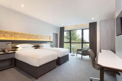 a hotel room with two beds and a desk at DoubleTree by Hilton Edinburgh - Queensferry Crossing in North Queensferry