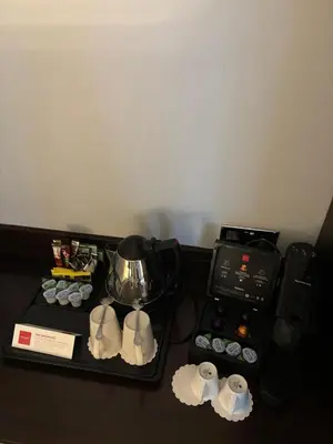 a table with a tea pot and a stove at Leonardo Edinburgh City in Edinburgh
