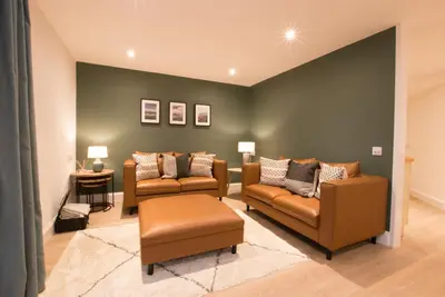 a living room with two chairs and a couch at Melfort Pier & Harbour Resort in Kilmelford