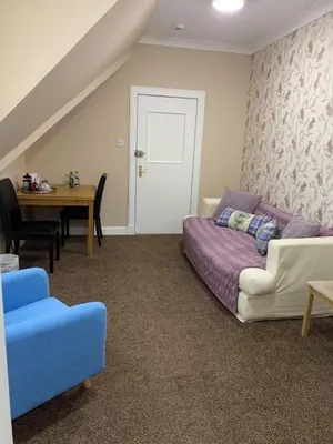 a living room with a couch and a table at No. 1 Charlotte Street in Port Ellen