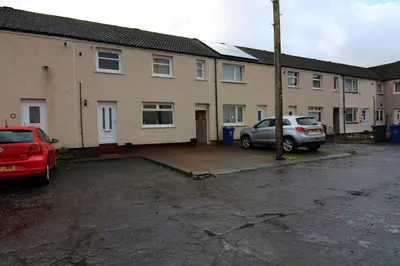 a car parked in a parking lot in front of a house at Signature - Atholl House Glasgow Airport in Paisley