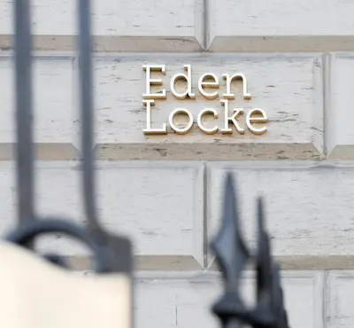 a sign on a brick wall with the words eden lodge at Eden Locke in Edinburgh