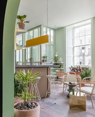 a room with chairs and a counter with plants at Eden Locke in Edinburgh