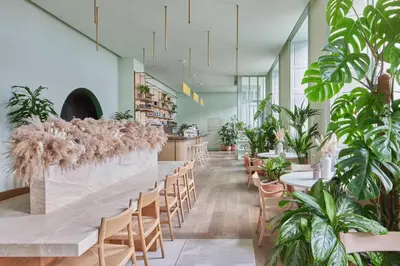 a long table in a restaurant with plants at Eden Locke in Edinburgh