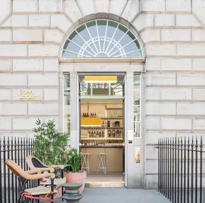 a store front with a table and chairs in front of a building at Eden Locke in Edinburgh