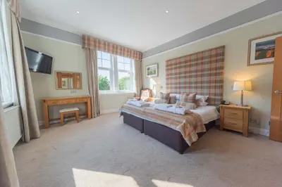 a bedroom with a large bed and a television at Tinto Hotel in Symington