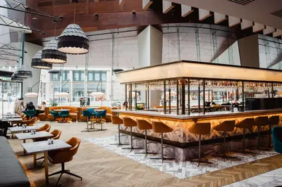 a bar in a restaurant with tables and chairs at Radisson Blu Hotel, Glasgow in Glasgow