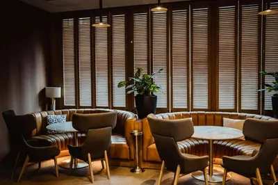 a restaurant with two tables and chairs and a couch at Radisson Blu Hotel, Glasgow in Glasgow