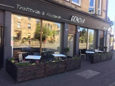 a restaurant with tables in the window of a store at Paisley Central Apartment #3 in Paisley