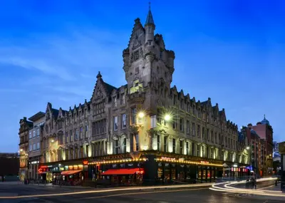 a large building on a city street at night at Fraser Suites Glasgow in Glasgow