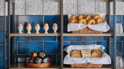 two shelves with baskets of bread and eggs on them at Fraser Suites Glasgow in Glasgow