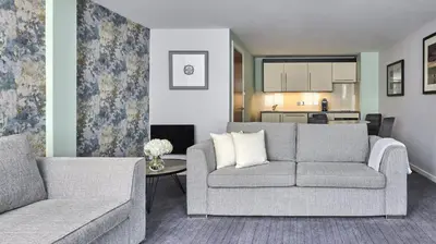 a living room with a couch and a table at Fraser Suites Glasgow in Glasgow