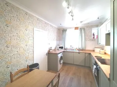 a kitchen with a table and a sink and a stove at bayviewapartment in Oban