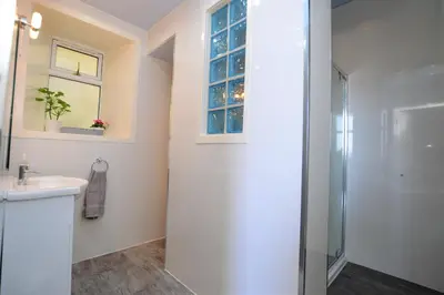 a bathroom with a shower and a sink at Sebright Holiday Apartment in Dunoon