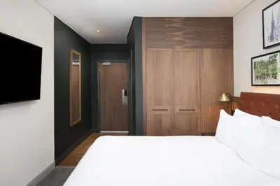 a hotel room with a bed and a door at Four Points by Sheraton Edinburgh in Edinburgh