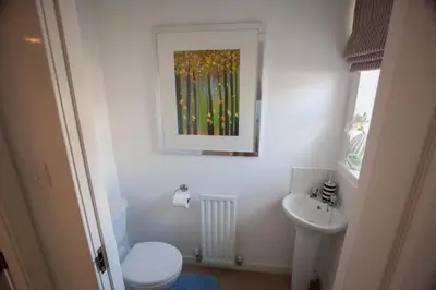 a bathroom with a white toilet and a sink at Glasgow Hampden House in Glasgow