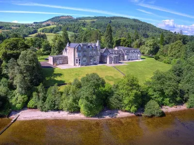 an aerial view of a large house on a green field at Benoch Lomond Castle in Alexandria