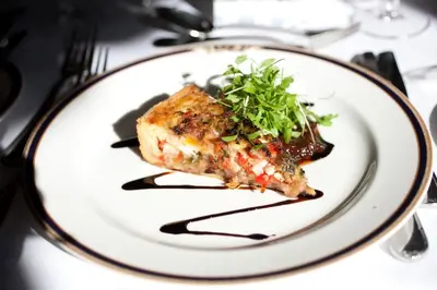 a plate with a slice of pizza on a table at Garvock House Hotel in Dunfermline