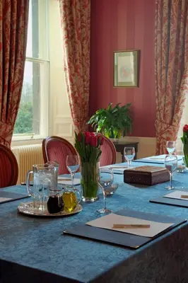 a table with wine glasses and flowers on it at Garvock House Hotel in Dunfermline