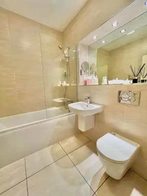 a bathroom with a toilet and a sink and a tub at Garvock House Hotel in Dunfermline