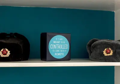 a black mug on a shelf with two stuffed animals at The Lothian Road Residence in Edinburgh