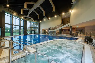 a large indoor swimming pool in a building at Cameron House on Loch Lomond in Balloch