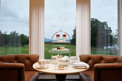 a table in a room with a large window at Cameron House on Loch Lomond in Balloch