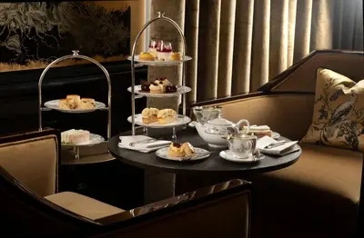 a table with three tiers of desserts on plates at Cameron House on Loch Lomond in Balloch