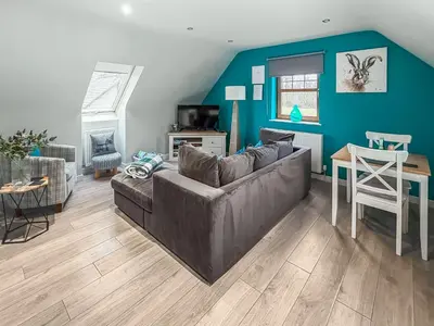 a living room with a couch and a table at The Snug in Harthill