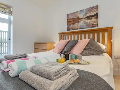 a bedroom with a bed with a tray of food on it at Woodend Barn in Auchterarder