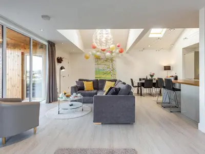 a living room with a couch and a table at Woodend Barn in Auchterarder