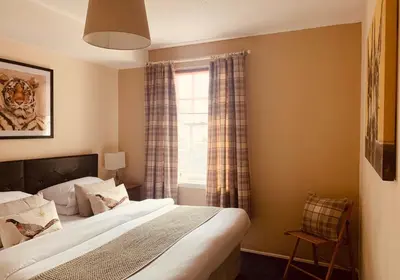 a bedroom with a bed and a window at The Webstersland Residence in Edinburgh