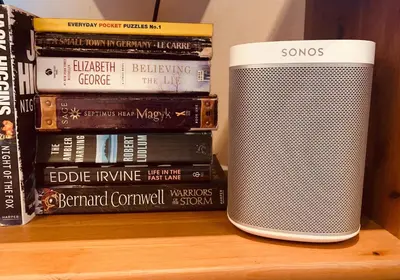 a speaker sitting next to a stack of books at The Webstersland Residence in Edinburgh