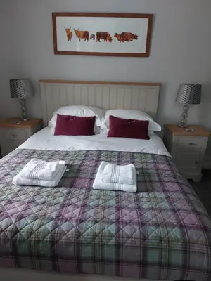 a bedroom with a bed with two towels on it at Cladich House Bed & Breakfast in Cladich