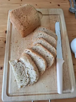 two slices of bread on a cutting board with a knife at Cladich House Bed & Breakfast in Cladich