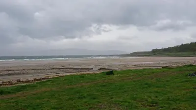 a view of a beach with people in the water at Sunnyside House in Rothesay