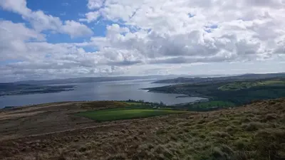 an aerial view of a golf course and a body of water at Sunnyside House in Rothesay