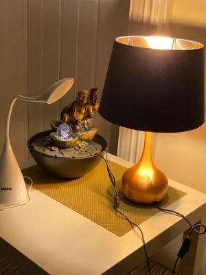 a lamp sitting on top of a table with a bowl at Loch Lomond Apartments in Dumbarton